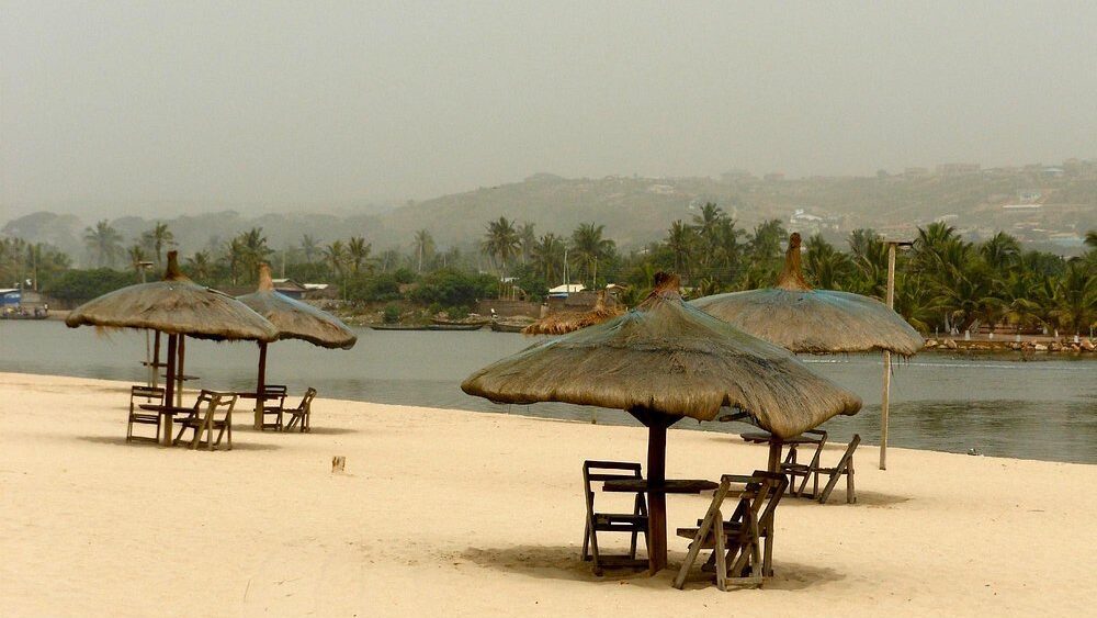 Am ocean beach. Tables with grass umbrellas over them. Bojo Beach. Photo courtesy of Ladida A